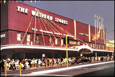 Colour photograph of a building saying the western stores, the shopping centre of Orange with crowds gathered outside